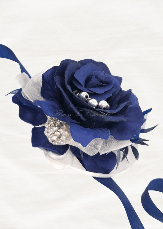 Artificial wedding wrist corsage with a navy blue faux rose, silver beads, a rhinestone accent and navy and sheer white ribbons. For formals, proms and ball occasions. Made in Melbourne by Flowers For Ever After, shipping Australia and Worldwide.