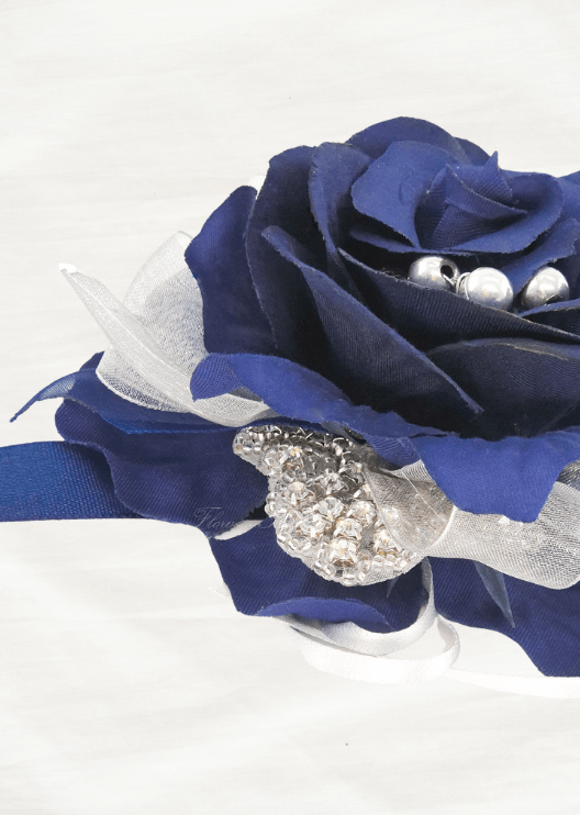 Artificial wedding wrist corsage close-up showing a navy faux rose, silver beads, a rhinestone accent and sheer white ribbon. For formals, proms and ball occasions. Made in Melbourne by Flowers For Ever After, shipping Australia and Worldwide.