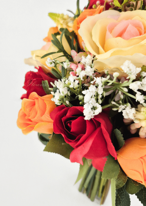 Artificial wedding bouquet close-up with red and orange faux roses, peach-cream rose, tiny white flowers and green leaves. Made in Melbourne by Flowers For Ever After, shipping Australia and Worldwide.