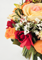 Artificial wedding bouquet close-up with red and orange faux roses, peach-cream rose, tiny white flowers and green leaves. Made in Melbourne by Flowers For Ever After, shipping Australia and Worldwide.