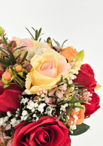 Artificial wedding bouquet detail showing red and peach-cream faux roses, small pink blossoms, berry buds and narrow green leaves. Made in Melbourne by Flowers For Ever After, shipping Australia and Worldwide.