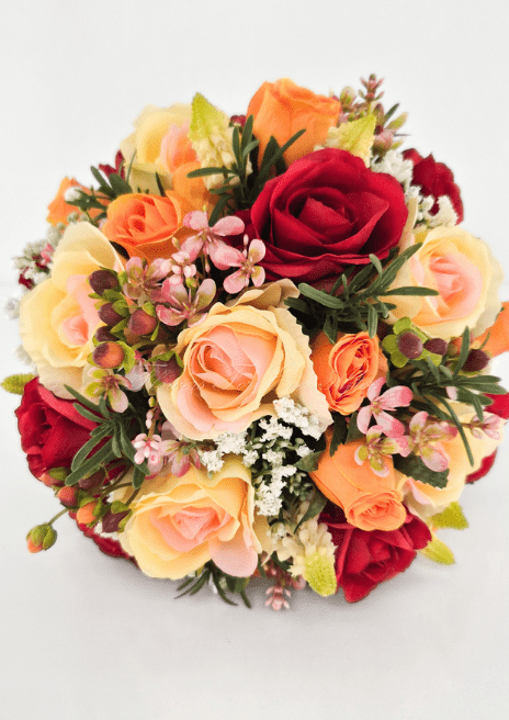 Artificial wedding bouquet, overhead view of red, orange and peach-cream faux roses, small pink blossoms and tiny white flowers. Made in Melbourne by Flowers For Ever After, shipping Australia and Worldwide.