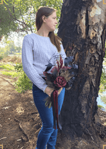 Artificial wedding bouquet held by a person, with black and burgundy faux calla lilies and roses, fine sprigs and long ribbon tails. Made in Melbourne by Flowers For Ever After, shipping Australia and Worldwide.