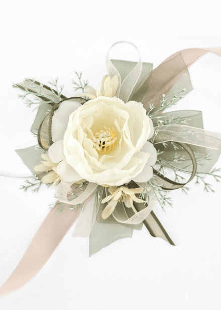 Artificial wedding wrist corsage with an ivory faux rose, cream star-shaped flowers, fine pale sprigs, olive and ivory ribbon loops and blush ribbon tails. For formals, proms and ball occasions. Made in Melbourne by Flowers For Ever After, shipping Australia and Worldwide.