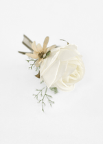 Artificial wedding boutonniere, overhead view of an ivory faux rose, cream star-shaped flower, pale sprigs and olive ribbons. For formals, proms and ball occasions. Made in Melbourne by Flowers For Ever After, shipping Australia and Worldwide.