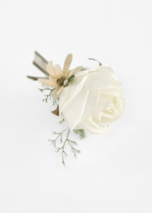 Artificial wedding boutonniere, overhead view of an ivory faux rose, cream star-shaped flower, pale sprigs and olive ribbons. For formals, proms and ball occasions. Made in Melbourne by Flowers For Ever After, shipping Australia and Worldwide.