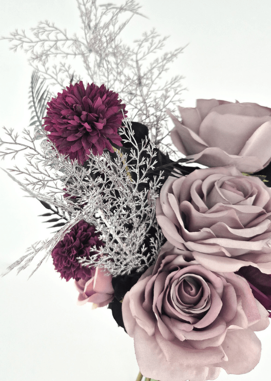 Artificial wedding bouquet close-up with dusty lilac faux roses, burgundy pompom blooms and fine silver branches. Made in Melbourne by Flowers For Ever After, shipping Australia and Worldwide.