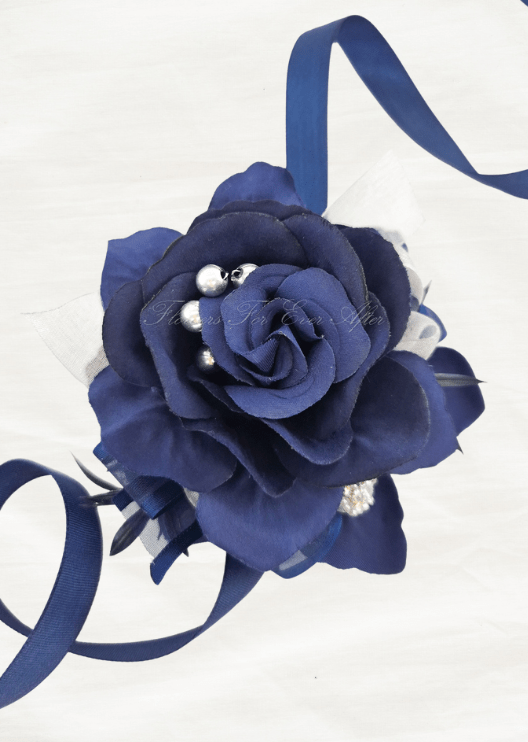 Artificial wedding wrist corsage, top view of a navy faux rose with silver beads, a rhinestone accent and navy ribbons. For formals, proms and ball occasions. Made in Melbourne by Flowers For Ever After, shipping Australia and Worldwide.