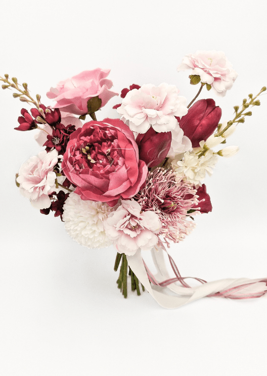 Artificial wedding bouquet close-up showing layered faux flower petals and green foliage. Made in Melbourne by Flowers For Ever After, shipping Australia and Worldwide.