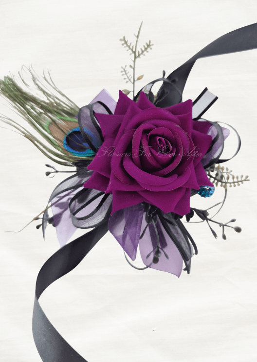 Artificial wedding wrist corsage with a magenta faux rose, peacock feather, purple and black ribbons and blue sparkling accents. For formals, proms and ball occasions. Made in Melbourne by Flowers For Ever After, shipping Australia and Worldwide.