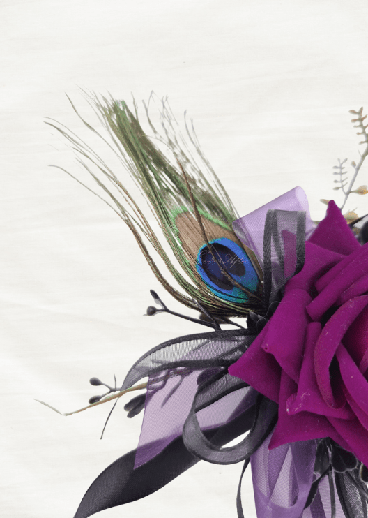 Artificial wedding corsage close-up showing a peacock feather beside a magenta faux rose and purple and black ribbon loops. For formals, proms and ball occasions. Made in Melbourne by Flowers For Ever After, shipping Australia and Worldwide.