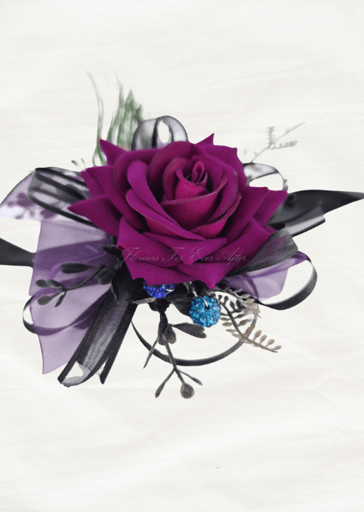 Artificial wedding wrist corsage, front view of a magenta faux rose, purple and black ribbons and blue sparkling accents. For formals, proms and ball occasions. Made in Melbourne by Flowers For Ever After, shipping Australia and Worldwide.