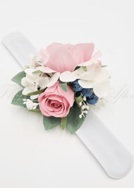 Artificial wedding wrist corsage, angled view of pink faux roses, pale flowers and trailing ivory ribbon. For formals, proms and ball occasions. Made in Melbourne by Flowers For Ever After, shipping Australia and Worldwide.