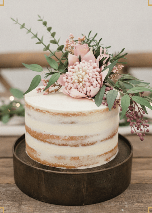 Artificial wedding cake flower set with pink faux waratah and native-style foliage in separate clusters. For birthday, event and celebration cakes. Made in Melbourne by Flowers For Ever After, shipping Australia and Worldwide.