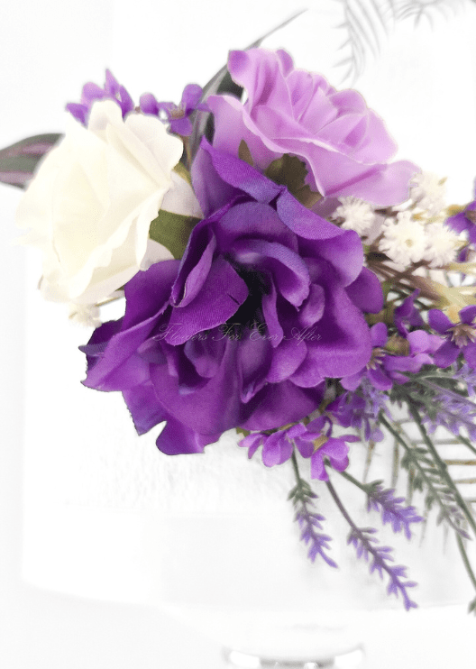 Artificial wedding cake flower close-up showing layered purple faux petals, a lilac rose, white rose and tiny white flowers. For birthday, event and celebration cakes. Made in Melbourne by Flowers For Ever After, shipping Australia and Worldwide.