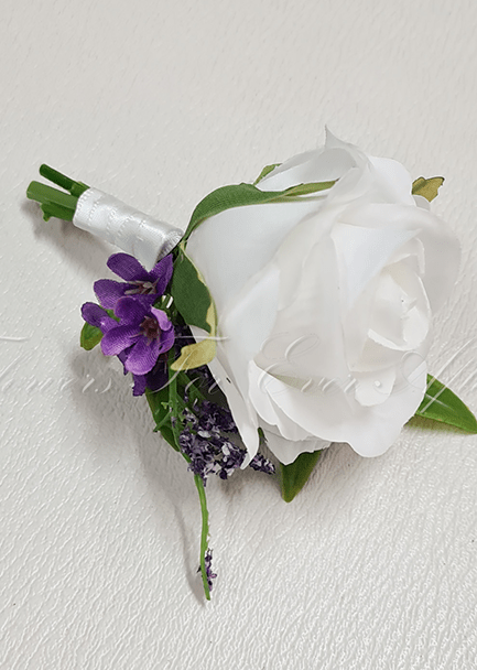 Artificial wedding groom boutonniere with a white faux rose, a smaller pale bloom, green leaves and wrapped stems. For formals, proms and ball occasions. Made in Melbourne by Flowers For Ever After, shipping Australia and Worldwide.