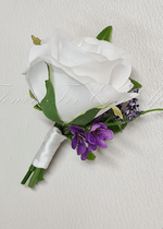 Artificial wedding groom boutonniere, top view of a white faux rose, pale blooms and green foliage. For formals, proms and ball occasions. Made in Melbourne by Flowers For Ever After, shipping Australia and Worldwide.