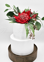 Artificial wedding cake decoration with red faux waratah flowers, yellow wattle and green native-style foliage. For birthday, event and celebration cakes. Made in Melbourne by Flowers For Ever After, shipping Australia and Worldwide.