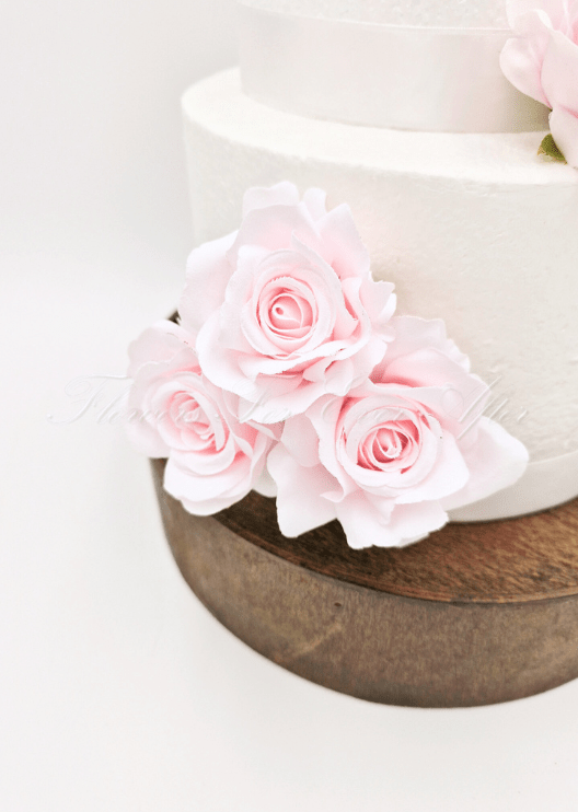 Artificial wedding cake decoration close-up with faux roses and green leaves. For birthday, event and celebration cakes. Made in Melbourne by Flowers For Ever After, shipping Australia and Worldwide.