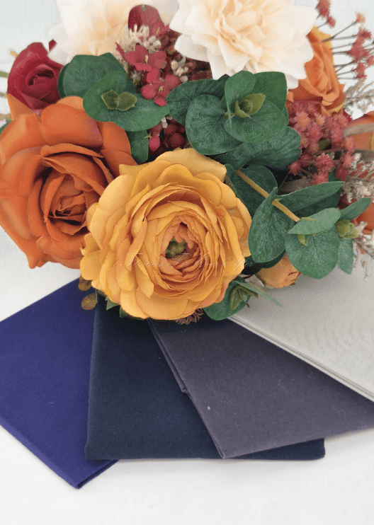 Artificial wedding bouquet colour pairing with rust and golden faux roses, cream dahlia, eucalyptus and blue, charcoal and grey fabric swatches. Made in Melbourne by Flowers For Ever After, shipping Australia and Worldwide.