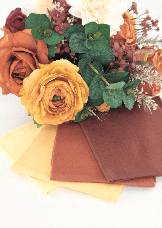 Artificial wedding bouquet colour pairing with rust and golden faux roses, eucalyptus and yellow, orange and rust fabric swatches. Made in Melbourne by Flowers For Ever After, shipping Australia and Worldwide.
