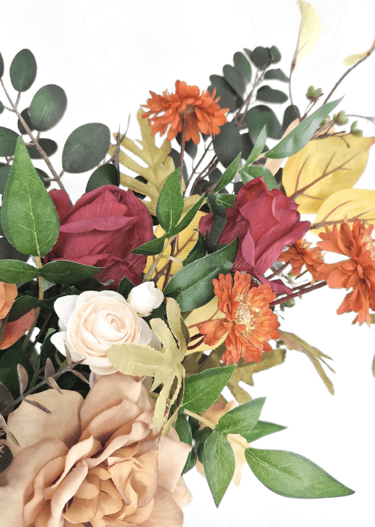 Artificial wedding arbor flower detail with burgundy faux rosebuds, orange daisies, white ranunculus and yellow leaves. Made in Melbourne by Flowers For Ever After, shipping Australia and Worldwide.