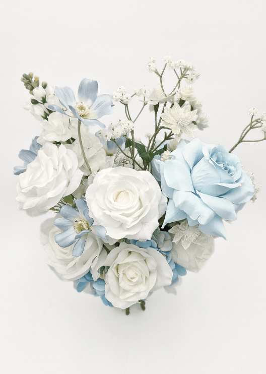 Artificial wedding bridesmaid bouquet with white faux roses, pale blue flowers, blue hydrangea and small white sprigs. Made in Melbourne by Flowers For Ever After, shipping Australia and Worldwide.