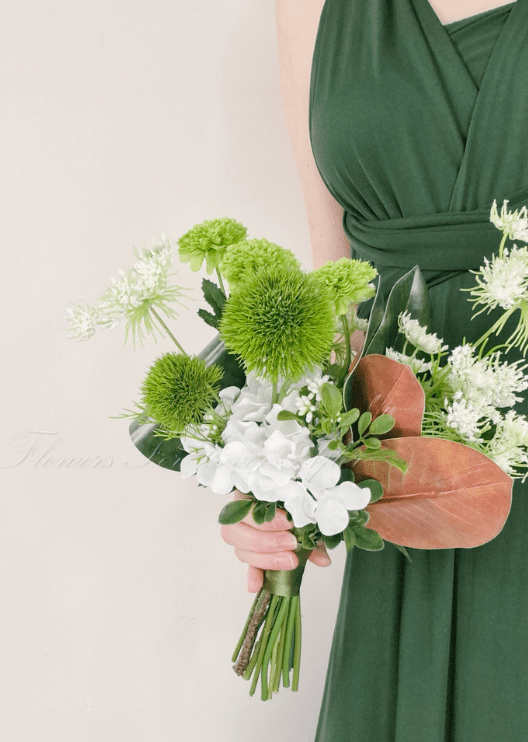 Artificial wedding bouquet, reverse view of white faux orchids, green pompom blooms, lime green flowers and brown leaves. Made in Melbourne by Flowers For Ever After, shipping Australia and Worldwide.