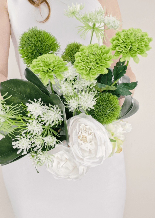 Artificial wedding bouquet close-up with white faux roses, lime green blooms, green pompom flowers and fine white sprigs. Made in Melbourne by Flowers For Ever After, shipping Australia and Worldwide.