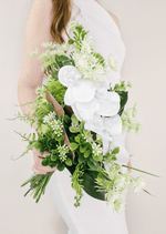 Artificial wedding bridal bouquet, side view of white faux orchids, small white flowers and mixed green foliage. Made in Melbourne by Flowers For Ever After, shipping Australia and Worldwide.