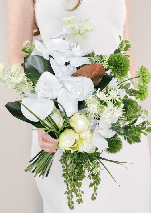 Artificial wedding bridal bouquet, handheld side view of white faux orchids, pale green blooms, fine white sprigs and trailing green buds. Made in Melbourne by Flowers For Ever After, shipping Australia and Worldwide.