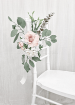Artificial wedding pew flower decoration close-up with blush and white faux roses, green leaves and ribbon ties. Made in Melbourne by Flowers For Ever After, shipping Australia and Worldwide.