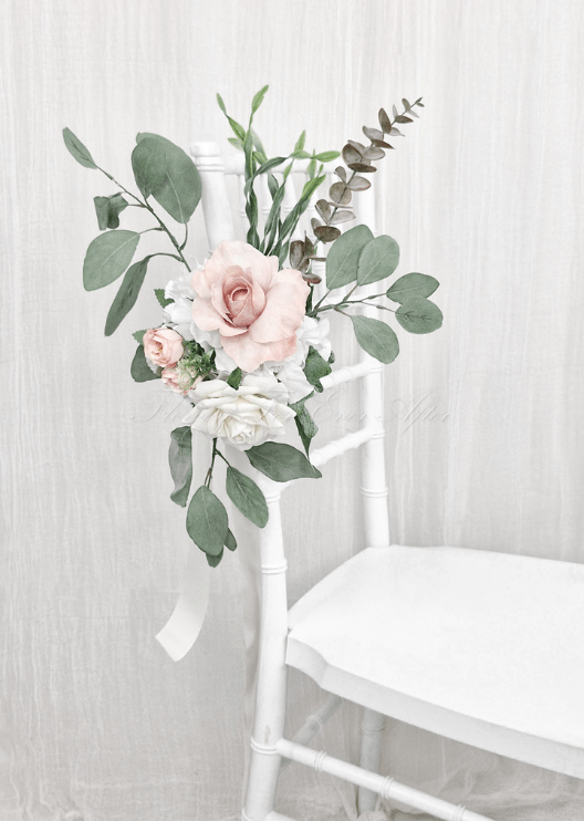 Artificial wedding pew flower decoration close-up with blush and white faux roses, green leaves and ribbon ties. Made in Melbourne by Flowers For Ever After, shipping Australia and Worldwide.