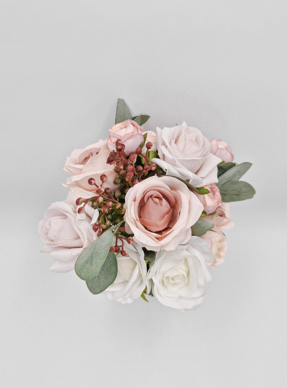 Artificial wedding flower girl posy, top view of blush and white faux roses with eucalyptus leaves and berry sprigs. Made in Melbourne by Flowers For Ever After, shipping Australia and Worldwide.