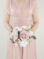 Artificial wedding bridesmaid posy held in both hands, featuring blush and white faux roses with eucalyptus and pale filler flowers. Made in Melbourne by Flowers For Ever After, shipping Australia and Worldwide.