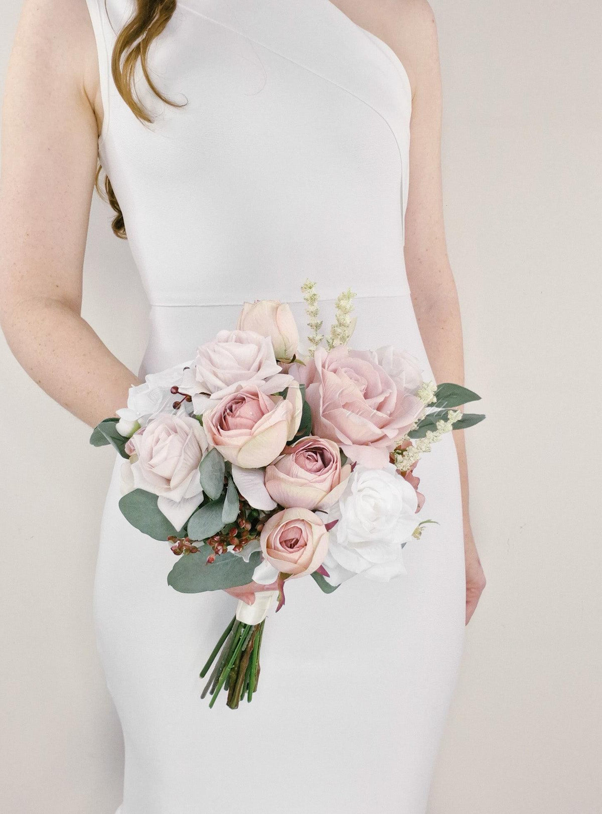 Artificial wedding bridesmaid posy with blush and white faux roses, eucalyptus leaves and a ribbon-wrapped handle with exposed stems. Made in Melbourne by Flowers For Ever After, shipping Australia and Worldwide.