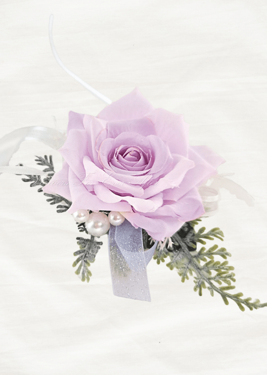 Artificial wedding wrist corsage with a pale lilac faux rose, pearl-style accents, fern-like foliage and white and lilac ribbons. For formals, proms and ball occasions. Made in Melbourne by Flowers For Ever After, shipping Australia and Worldwide.