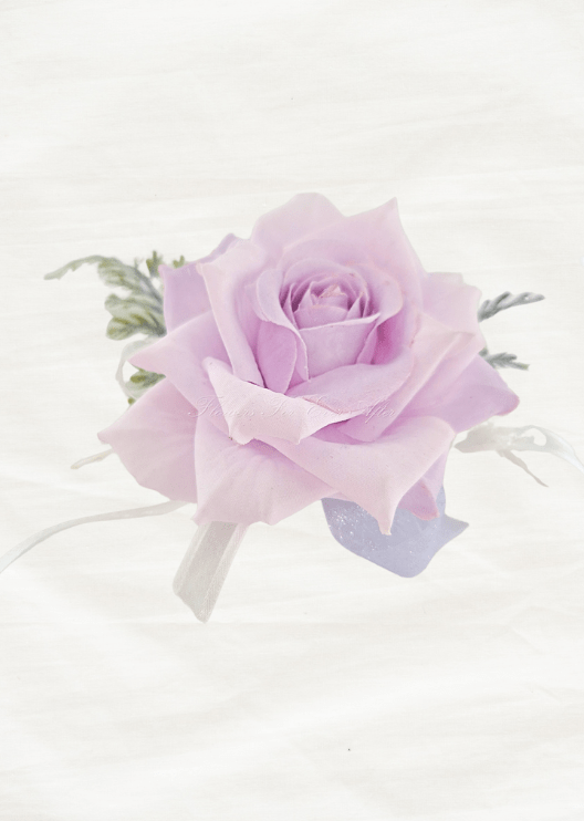 Artificial wedding wrist corsage, side view of a pale lilac faux rose with white and lilac ribbon loops and fern-like foliage. For formals, proms and ball occasions. Made in Melbourne by Flowers For Ever After, shipping Australia and Worldwide.