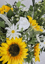 Artificial wedding arbor flowers, angled view of yellow faux sunflowers, white blooms and cascading greenery. Made in Melbourne by Flowers For Ever After, shipping Australia and Worldwide.