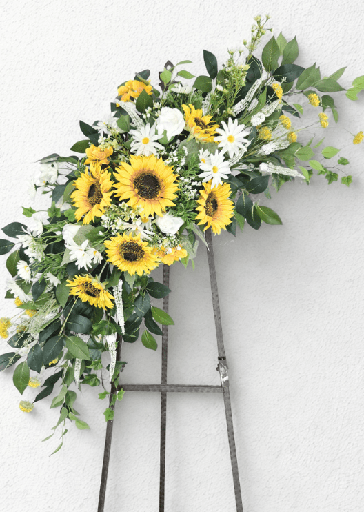 Artificial wedding arbor decoration with yellow faux sunflowers, white flowers and trailing green foliage in two asymmetric arrangements. Made in Melbourne by Flowers For Ever After, shipping Australia and Worldwide.