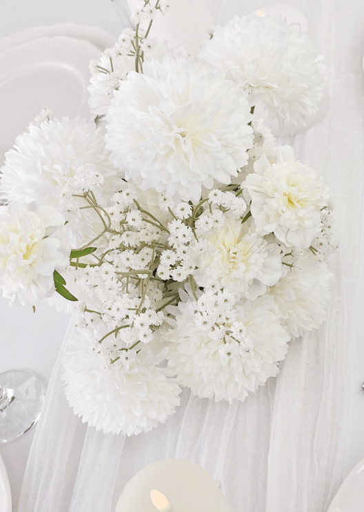 Artificial wedding table centrepiece close-up showing white faux blooms and green foliage. Made in Melbourne by Flowers For Ever After, shipping Australia and Worldwide.