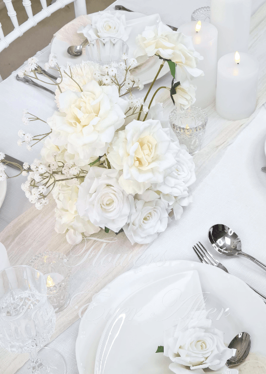Artificial wedding table centrepiece, angled view of ivory and white faux roses, large cream flowers and branching baby's breath. Made in Melbourne by Flowers For Ever After, shipping Australia and Worldwide.