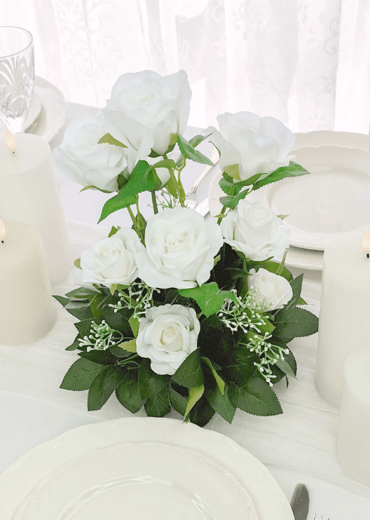 Artificial wedding table flower arrangement with clustered white faux blooms and green foliage. Made in Melbourne by Flowers For Ever After, shipping Australia and Worldwide.