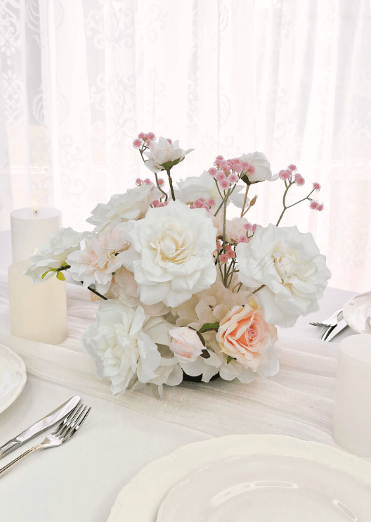 Artificial wedding table arrangement, angled view of clustered white faux flowers and pale sprigs. Made in Melbourne by Flowers For Ever After, shipping Australia and Worldwide.