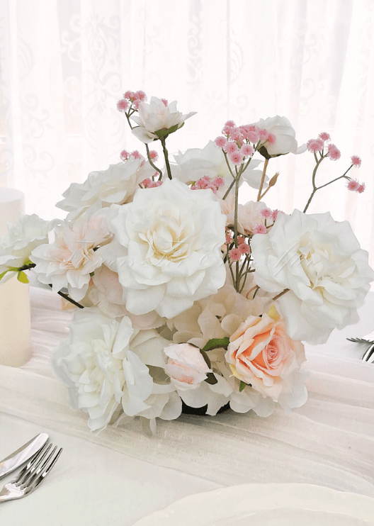 Artificial wedding table arrangement with white faux flowers and pale filler sprigs. Made in Melbourne by Flowers For Ever After, shipping Australia and Worldwide.