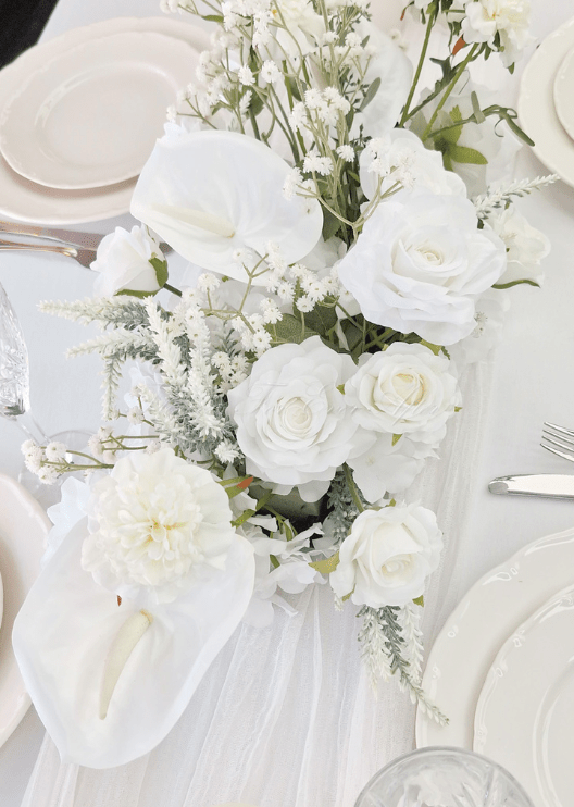 Artificial wedding low table arrangement close-up with white faux roses, white orchids, hydrangea and small filler flowers. Made in Melbourne by Flowers For Ever After, shipping Australia and Worldwide.