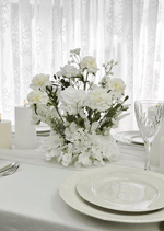 Artificial wedding table arrangement close-up showing layered faux flower petals and green foliage. Made in Melbourne by Flowers For Ever After, shipping Australia and Worldwide.