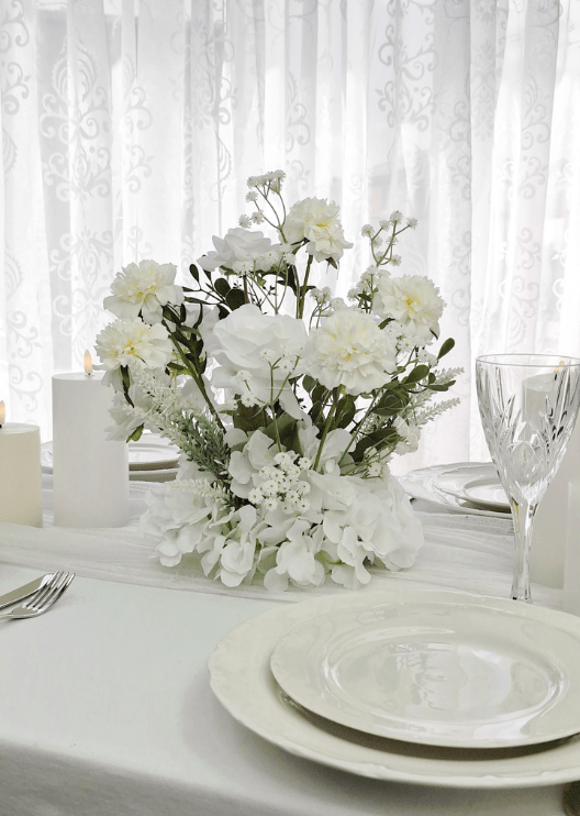 Artificial wedding table arrangement close-up showing layered faux flower petals and green foliage. Made in Melbourne by Flowers For Ever After, shipping Australia and Worldwide.