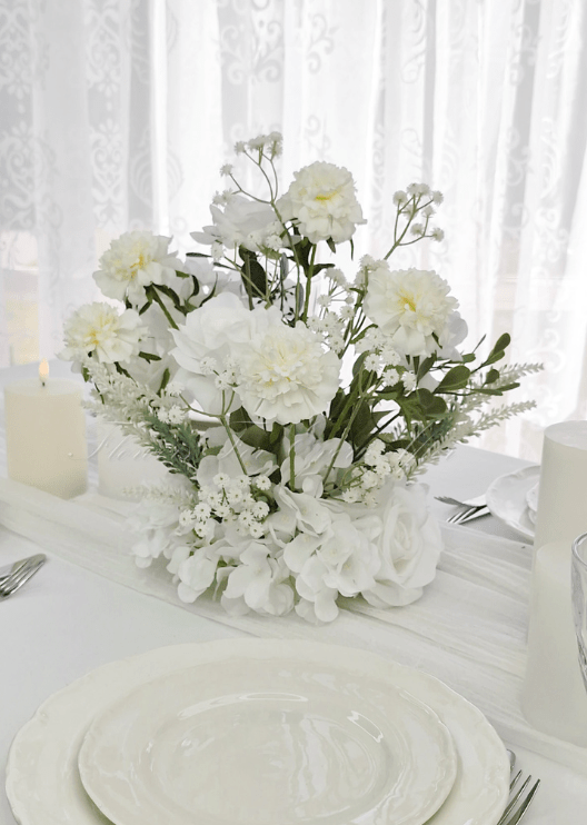 Artificial wedding table arrangement, angled view of mixed faux flowers and green leaves. Made in Melbourne by Flowers For Ever After, shipping Australia and Worldwide.