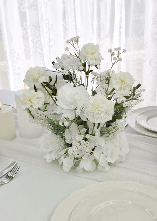 Artificial wedding table centrepiece, front view of mixed faux blooms and green leaves. Made in Melbourne by Flowers For Ever After, shipping Australia and Worldwide.